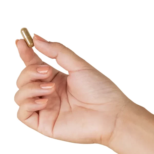 Inner Balance hemp powder capsule held between index finger and thumb