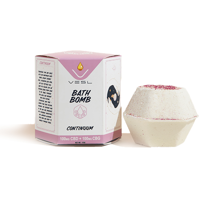 white and red continuum bath bomb made with cbd and cbg next to pink vesl brand packaging on white background